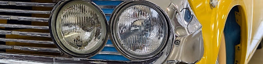 Close-up of a round chrome headlight and grille on a vintage American car, showing the unadorned period-correct lighting form common to pre- and post-war hot rods