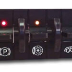 Custom hot rod switch panel with illuminated function indicators: parking brake, cooling fan, headlights, and oil pressure warning switches with colored LED lights