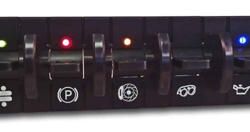 Custom hot rod switch panel with illuminated function indicators: parking brake, cooling fan, headlights, and oil pressure warning switches with colored LED lights